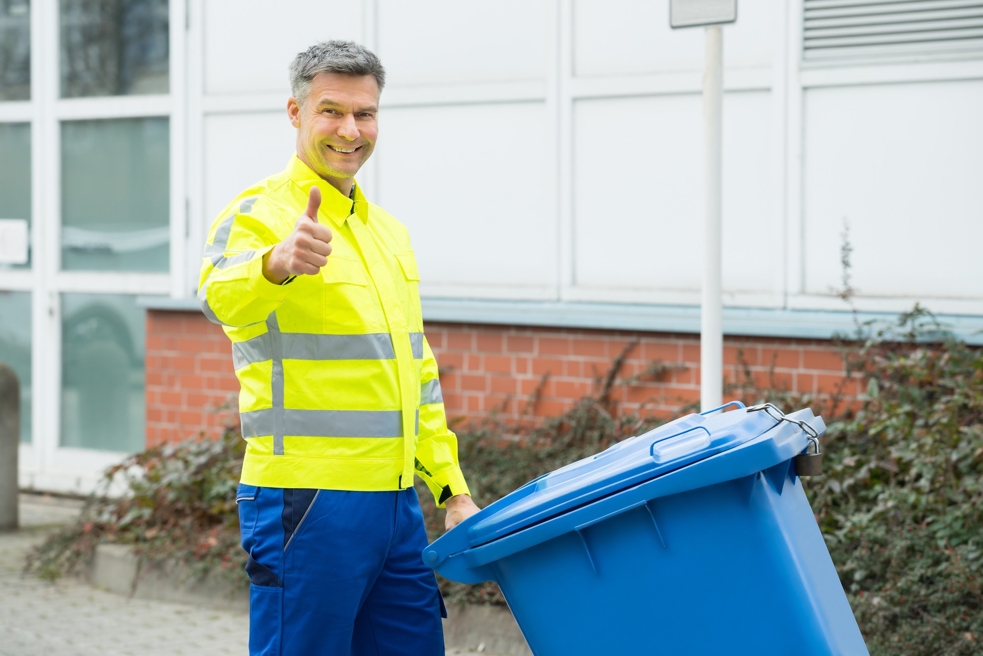 Working Man Holding Dustbin On Street